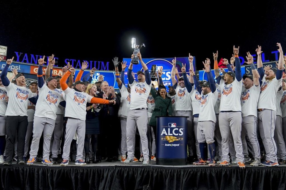 The Houston Astros celebrate with the American League Championship trophy after defeating the New York Yankees in Game 4 to win the American League Championship baseball series, Monday, Oct. 24, 2022, in New York. (AP Photo/John Minchillo)