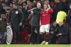 Manchester United's Christian Eriksen talks with head coach Erik ten Hag as he prepares to come onto the field during the English Premier League soccer match between Manchester United and Tottenham Hotspur at Old Trafford in Manchester, England, Wednesday, Oct. 19, 2022. (AP Photo/Dave Thompson)
