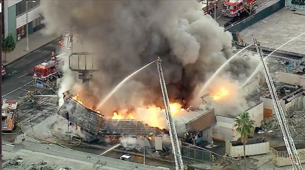 Firefighters battle a structure fire in North Hollywood, Calif., on Wednesday, Oct. 26, 2022. A raging fire destroyed a vacant commercial building in Los Angeles early Wednesday and numerous other small fires broke out in the same area, triggering an arson investigation in which one person was detained, authorities said. (KABC via AP)