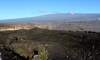 FILE - Hawaii's Mauna Loa volcano, background, towers over the summit crater of Kilauea volcano in Hawaii Volcanoes National Park on the Big Island on April 25, 2019. Hawaii officials are warning residents of the Big Island to prepare for the possibility that the world's largest active volcano may erupt given a recent spike in earthquakes at the summit of Mauna Loa. Scientists don't expect the volcano to erupt imminently, but officials are reminding people lava could reach some homes in just a few hours when it does. (AP Photo/Caleb Jones, File)