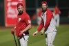 Philadelphia Phillies left fielder Kyle Schwarber, left, and Philadelphia Phillies designated hitter Bryce Harper (3) warm up ahead of Game 1 of the baseball World Series between the Houston Astros and the Philadelphia Phillies on Thursday, Oct. 27, 2022, in Houston. Game 1 of the series starts Friday. (AP Photo/David J. Phillip)
