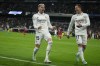 Real Madrid's Federico Valverde, left, celebrates with Lucas Vazquez after scoring his side's third goal during the Spanish La Liga soccer match between Real Madrid and Sevilla at the Santiago Bernabeu stadium in Madrid, Saturday, Oct. 22, 2022. (AP Photo/Manu Fernandez)
