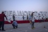 People take photographs in front of a sign representing FIFA World Cup 2022, on Doha's corniche, only 30 days away from the event, in Qatar, Friday, Oct. 21, 2022. Canada Soccer added its voice Friday to the push for greater workers' rights and inclusivity in Qatar as the country prepares to host next month's FIFA World Cup. THE CANADIAN PRESS/AP, Nariman El-Mofty