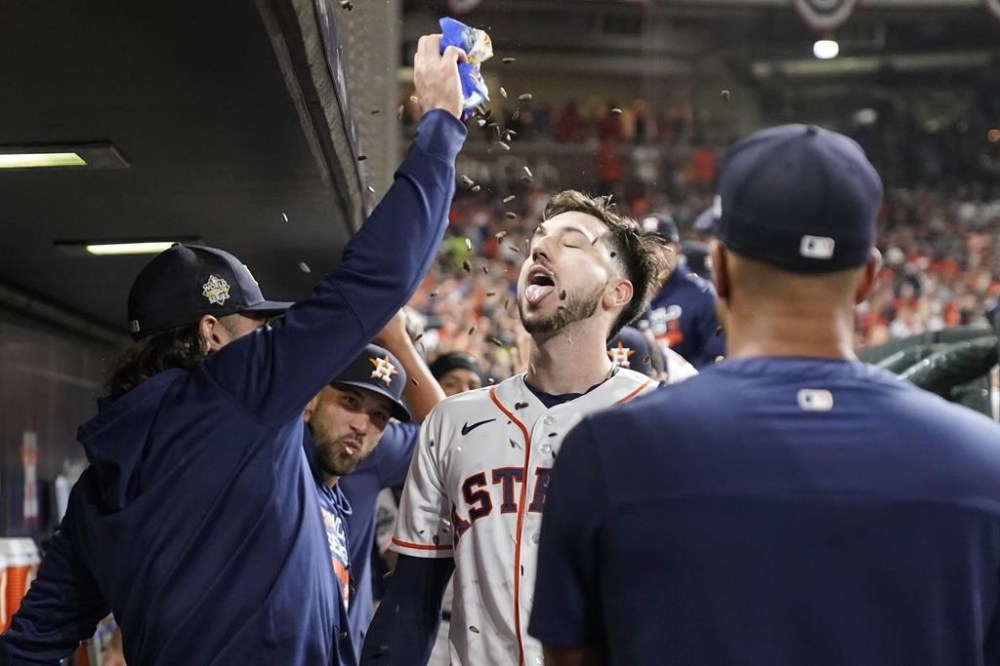 Houston Astros' Kyle Tucker celebrates his three-run home run in dugout during the third inning in Game 1 of baseball's World Series between the Houston Astros and the Philadelphia Phillies on Friday, Oct. 28, 2022, in Houston. (AP Photo/Eric Gay)