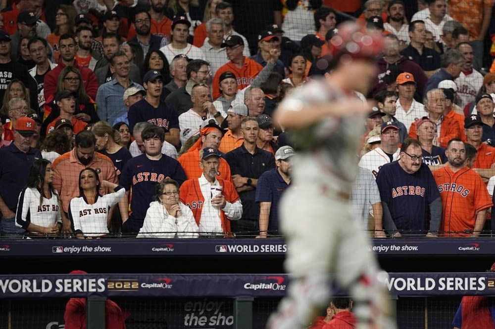 Houston Astros fans watch as the Philadelphia Phillies celebrate their win in Game 1 of baseball's World Series between the Houston Astros and the Philadelphia Phillies on Friday, Oct. 28, 2022, in Houston. The Phillies won 6-5 to take a one game lead in the series. (AP Photo/David J. Phillip)