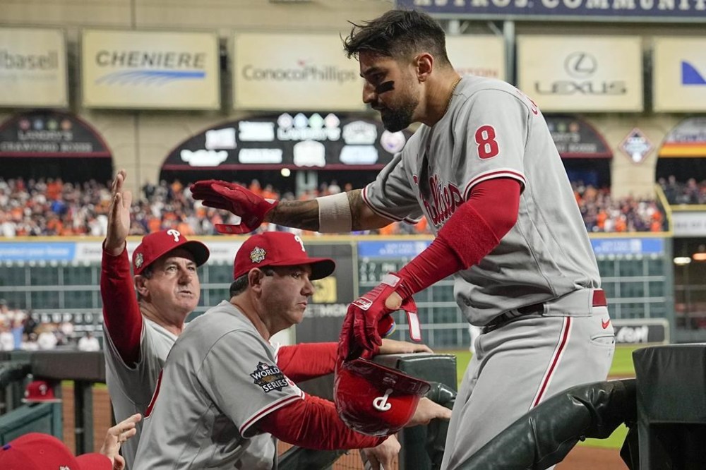 Philadelphia Phillies' Nick Castellanos celebrates after scoring on a double hit by Alec Bohm during the fourth inning in Game 1 of baseball's World Series between the Houston Astros and the Philadelphia Phillies on Friday, Oct. 28, 2022, in Houston. (AP Photo/David J. Phillip)