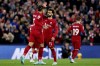Liverpool's Mohamed Salah, center, celebrates with team-mate Roberto Firmino after scoring their side's first goal of the game during the Premier League match between Liverpool and Leeds United at Anfield, Liverpool, Saturday Oct. 29, 2022. (Richard Sellers/PA via AP)