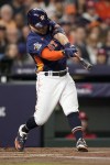 Houston Astros' Jose Altuve hits a double during the first inning in Game 2 of baseball's World Series between the Houston Astros and the Philadelphia Phillies on Saturday, Oct. 29, 2022, in Houston. (AP Photo/David J. Phillip)