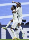 Real Madrid's Vinicius Junior, left, celebrates with Rodrygo after scoring his side's opening goal during a Spanish La Liga soccer match between Real Madrid and Girona at the Santiago Bernabeu stadium in Madrid, Spain, Sunday, Oct. 30, 2022. (AP Photo/Jose Breton)