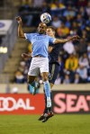 NYCFC's Heber, left, and Philadelphia Union's Jack Elliott, right, leap for a header during the first half of an MLS soccer match, Sunday, Oct. 30, 2022, in Chester, Pa. (AP Photo/Chris Szagola)
