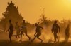 FILE- Young boys play soccer on a dusty field in Duduza, east of Johannesburg, South Africa, June 23, 2021. Soccer has embarked on probably its most ambitious global youth development program, an ultimate goal of delivering millions of soccer balls and a coaching program to 700 million children aged between 4 and 14 across the world. The Football For Schools project was launched in 2019 but came to a grinding halt because of the COVID-19 pandemic. It has now been relaunched. (AP Photo/Themba Hadebe, file)