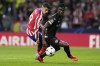 Leverkusen's Odilon Kossounou, right, and Atletico Madrid's Alvaro Morata challenge for the ball during the group B Champions League soccer match between Atletico Madrid and Bayer 04 Leverkusen at the Civitas Metropolitano stadium in Madrid, Spain, Wednesday, Oct. 26, 2022. (AP Photo/Manu Fernaandez)