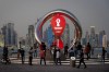 FILE - People gather around the official countdown clock showing remaining time until the kick-off of the World Cup 2022, in Doha, Qatar, Thursday, Nov. 25, 2021. Qatar will host the 2022 FIFA World Cup but soccer isn't the only sport played in the Gulf Arab country. From traditional pursuits to worldwide competitions, Qatar increasingly has marketed itself as a host for sports of all sorts. (AP Photo/Darko Bandic, File)