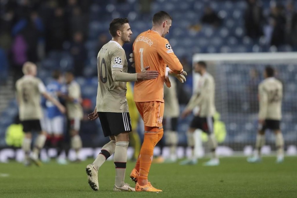 Rangers' goalkeeper Allan McGregor, right walks from the pitch with Ajax's Dusan Tadic after the end of theChampions League group A soccer match between, Glasgow Rangers and Ajax, at Ibrox stadium in Glasgow, Scotland, Tuesday, Nov. 1, 2022. Ajak won the match 3-1. (AP Photo/Scott Heppell)