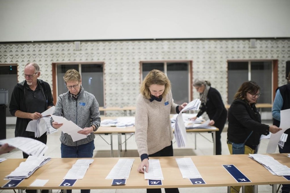 A members of the local electoral commission counts votes at the polling station at Odense Town Hall in Odense, Denmark, Tuesday Nov. 1, 2022. Denmark's election on Tuesday is expected to change its political landscape, with new parties hoping to enter parliament and others seeing their support dwindle. (Tim Kildeborg Jensen/Ritzau Scanpix via AP)