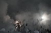 Maccabi fans use smoke grenades during Champions League match between Maccabi Haifa and Benfica in Haifa, Wednesday, Nov. 2, 2022. (AP Photo/Ariel Schalit)