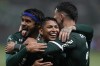 Palmeiras' Rony, center, celebrates with teammates Gustavo Scarpa, left, and Piquerez after scoring during a Brazilian soccer league match against Fortaleza in Sao Paulo, Brazil, Wednesday, Nov. 2, 2022. (AP Photo/Andre Penner)