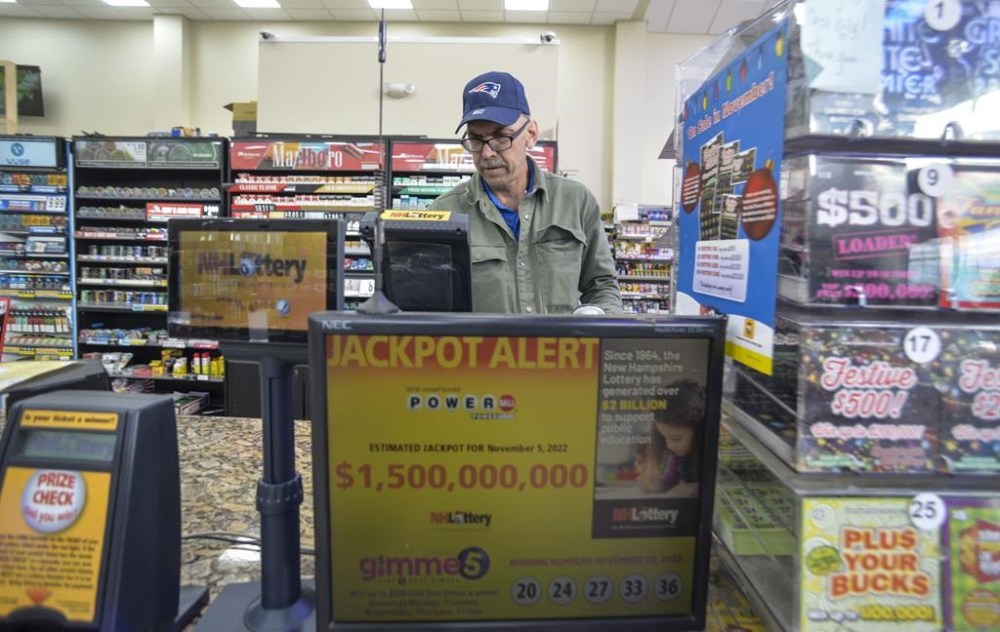 Bruce Gideos, floor manager at Pierre's Place, in Chesterfield, N.H., prints out Powerball tickets on Thursday, Nov. 3, 2022. The Powerball jackpot climbed over $1.5 billion on Thursday after no one won Wednesday's drawing. (Kristopher Radder/The Brattleboro Reformer via AP)