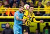 Dortmund's Giovanni Reyna, right, and Kostas Stafylidis of Bochum jump for the ball during a German Bundesliga soccer match between Borussia Dortmund and VfL Bochum in Dortmund, Germany, Saturday, Nov.5, 2022. (Bernd Thissen/dpa via AP)