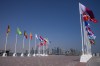 Flags on poles in front of the official FIFA World Cup Countdown Clock on Doha's corniche, Qatar, Wednesday, Oct. 19, 2022. One of the world’s biggest sporting events has thrown an uncomfortable spotlight on Qatar’s labor system, which links workers’ visas to employers and keeps wages low for workers toiling in difficult conditions. (AP Photo/Nariman El-Mofty)