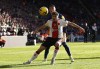 Southampton's Romain Perraud, left, and Newcastle United's Miguel Almiron battle for the ball during the English Premier League soccer match between Southampton and Newcastle United at St. Mary's Stadium, Southampton, England, Sunday Nov. 6, 2022. (Steven Paston/PA via AP)
