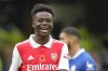 Arsenal's Bukayo Saka smiles after scoring the opening goal during the English Premier League soccer match between Chelsea and Arsenal at Stamford Bridge Stadium in London, Sunday, Nov. 6, 2022. (AP Photo/Kirsty Wigglesworth)
