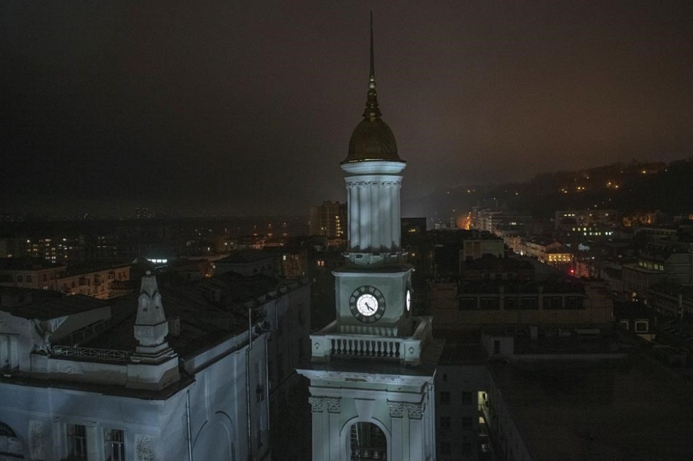 A tower of the National Bank of Ukraine is seen during a blackout in Kyiv, Ukraine, Sunday, Nov. 6, 2022. (AP Photo/Andrew Kravchenko)
