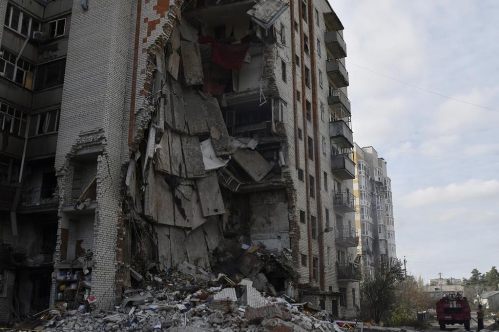 Firefighters work at the scene of a damaged residential building after Russian shelling in the liberated Lyman, Donetsk region, Ukraine, Monday, Nov. 7, 2022. (AP Photo/Andriy Andriyenko)