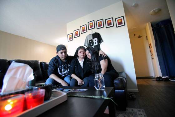 CJ's mother Laureen and siblings John and Sarah Mowat embrace while speaking about their son and brother. (Erik Pindera / Winnipeg Free Press)