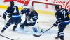 John Woods / THE CANADIAN PRESS
                                Jets goaltender David Rittich keeps his eye on the rebound as Dominic Toninato and Neal Pionk watch the front of the net Wednesday night at Canada Life Centre.
