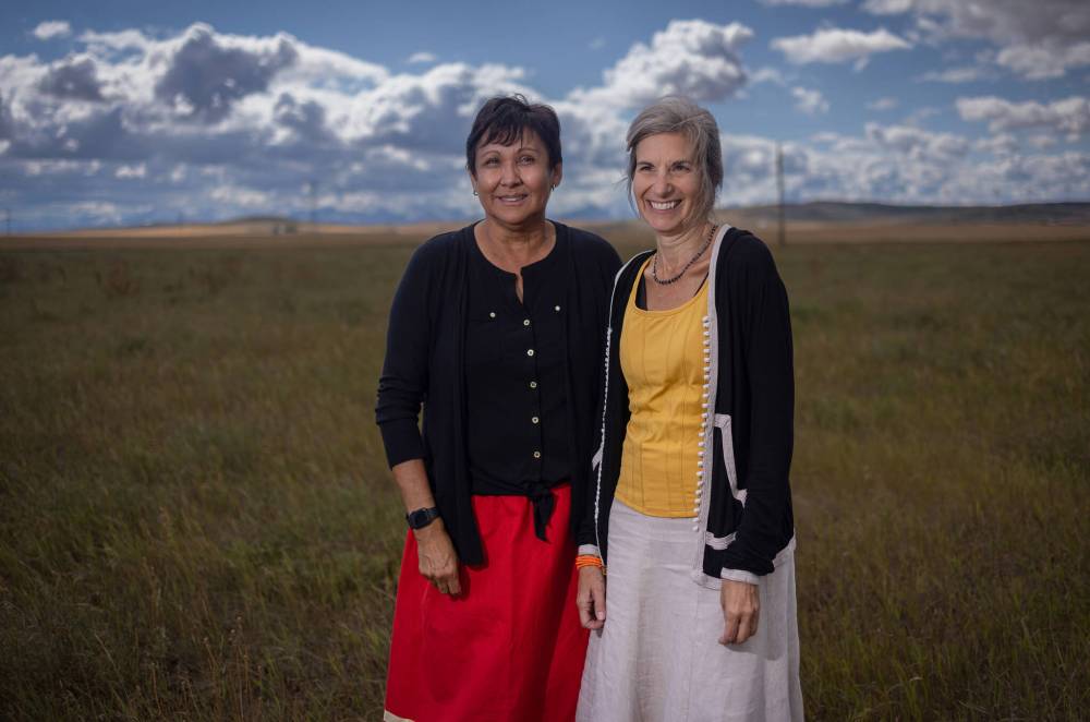 LEAH HENNEL / THE NARWHAL
Noreen Plain Eagle, manager of Piikani Lands , left and Laura Lynes, president of The Resilience Institute after seed ceremony with a team of scientists who will explore the potential of Sweetgrass to sequester carbon at Piikani Nation in Alberta.