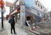 JOHN WOODS / WINNIPEG FREE PRESS FILES
                                A passer-by checks out the damage to Pizzarama on Selkirk after the car crash in April. The driver, who was fleeing police, was killed in the crash.