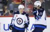 Jeff McIntosh / THE CANADIAN PRESS
                                Nikolaj Ehlers and Adam Lowry celebrate Ehlers first period goal Friday night in Calgary.