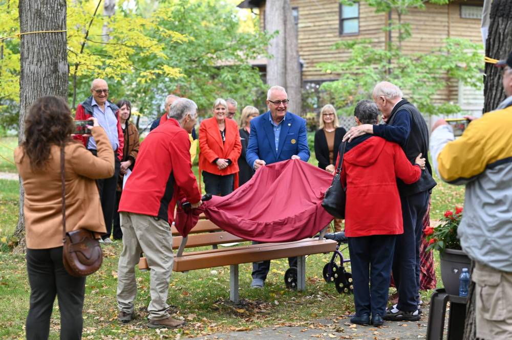 KELSEY JAMES / CANSTAR The Fort Garry Rotary Club marked 60 years of service by honouring longtime member Ted Foreman, far right with wife Lynn, at a ceremony on October 3. Foreman joined the Fort Garry Rotary Club in 1962 because he was interested in helping others. Now, six decades later, the club unveiled a new bench near Wildwood Park acknowledging Foreman’s service to the community.