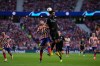 Canadian Tajon Buchanan of Brugges (right) leaps for a header against Atletico Madrid&rsquo;s Angel Correa during Champions League action Wednesday in Madrid. A key to his Belgian club team, Buchanan could prove to be a thorn in the side of Belgium at the World Cup. (Manu Fernandez / The Associated Press)
