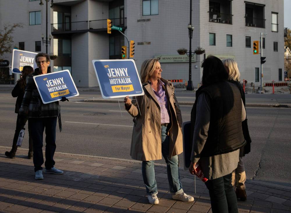 Jenny Motkaluk and some of her supporters protested her exclusion from the debate in front of the CBC during rush hour on Wednesday. (Winnipeg Free Press)