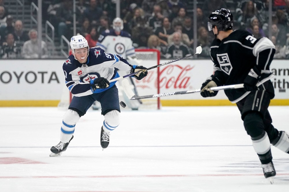(AP Photo/Mark J. Terrill)
Winnipeg Jets' Cole Perfetti chases the puck past Los Angeles Kings defenceman Matt Roy during the first period Thursday in Los Angeles. Listed at 5-11 and 177 pounds, Perfetti is undersized by NHL standards.