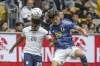 FILE - Japan's Machino Shuto, right, and Reggie Cannon from the USA try to get the ball during the international friendly soccer match between USA and Japan as part of the Kirin Challenge Cup in Duesseldorf, Germany, Friday, Sept. 23, 2022. Japan Football announced Tuesday, Nov. 8, 2022, that they have named forward Shuto Machino to replace injured defender Yuta Nakayama on its World Cup team for Qatar. (Bernd Thissen/dpa via AP, File)