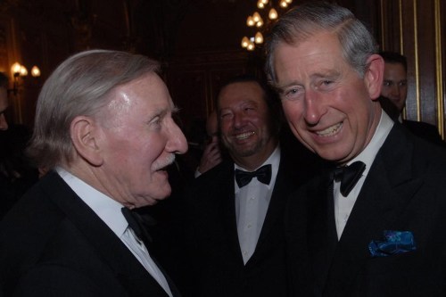Britain's Prince Charles chats with actor Leslie Philips at the Royal Shakespeare Company's gala fund raising dinner for their 'Complete Works Festival', in London, on May 17, 2006. Leslie Phillips, the British actor best known for his roles in the bawdy “Carry On” comedies and as the voice of the Sorting Hat in the “Harry Potter” movies, has died. He was 98. His agent Jonathan Lloyd confirmed Tuesday that Phillips died “peacefully at home” on Monday. (Stefan Rousseau/Pool Photo via AP)