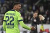 Wolfsburg's Felix Nmecha who scored the second goal, celebrates a win against Borussia after the end of the German Bundesliga soccer match between VfL Wolfsburg and Borussia Dortmund in Wolfsburg, Germany, Tuesday, Nov. 8, 2022. (AP Photo/Michael Sohn)