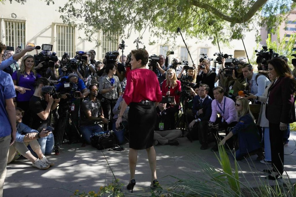 Kari Lake, Arizona Republican candidate for governor, gets ready to answer questions from the media after voting on election day in Phoenix, Tuesday, Nov. 8, 2022. (AP Photo/Ross D. Franklin)