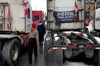 People walk past a truck bearing a flag calling for Conservative MP Pierre Poilievre to become Prime Minister, during the “Freedom Convoy” protest, in Ottawa, on Feb. 16, 2022. Poilievre says he stands by his support of the convoy, but will wait until a public inquiry on the matter is over before weighing in on evidence. THE CANADIAN PRESS/Justin Tang