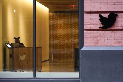 FILE - A receptionist works in the lobby of the building that houses the Twitter office in New York, Wednesday, Oct. 26, 2022. Elon Musk has emailed Twitter employees ordering them to return to the office starting Thursday for at least 40 hours a week and warning of “difficult times ahead.” (AP Photo/Mary Altaffer)