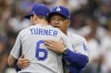 Los Angeles Dodgers manager Dave Roberts, right, hugs shortstop Trea Turner before Game 3 of a baseball NL Division Series against the San Diego Padres, Friday, Oct. 14, 2022, in San Diego. (AP Photo/Jae C. Hong)