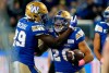 Winnipeg Blue Bombers' Greg McCrae (29) and Brady Oliveira (20) celebrate Oliveira’s touchdown against the Edmonton Elks during first half CFL action in Winnipeg on October 8, 2022. Oliveira will make his first post-season start at running back when the team hosts the B.C. Lions in Sunday’s CFL West Division final at IG Field. THE CANADIAN PRESS/John Woods