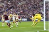 Leicester City goalkeeper Danny Ward, right, saves a shot from West Ham United's Craig Dawson, during the English Premier League soccer match between West Ham United and Leicester City at the London Stadium, in London, Saturday, Nov. 12, 2022. (James Manning/PA via AP)