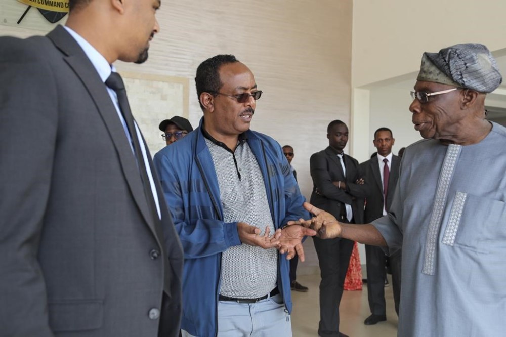 The Ethiopian government's lead negotiator Redwan Hussein, center, speaks with African Union envoy and former Nigerian president Olesegun Obasanjo, right, at Ethiopian peace talks in Nairobi, Kenya Saturday, Nov. 12, 2022. A new round of ongoing talks aims to work out military and other details of last week's signing of a