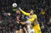 Spezia's goalkeeper Bartlomiej Dragowski, right, saves on AC Milan's Olivier Giroud during the Serie A soccer match between AC Milan and Spezia at the San Siro stadium, in Milan, Italy, Saturday, Nov. 5, 2022. (AP Photo/Antonio Calanni)