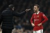 Fulham's head coach Marco Silva, left, speaks with Manchester United's Christian Eriksen during the English Premier League soccer match between Fulham and Manchester United at the Craven Cottage stadium in London, Sunday, Nov. 13, 2022. (AP Photo/Leila Coker)