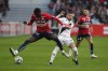 Lille's Timothy Weah, left, avoids a tackle by Angers' Farid el Melali during the French League One match Lille against Angers at the Pierre Mauroy stadium Sunday, Nov. 13, 2022 in Lille, northern France. (AP Photo/Michel Spingler)